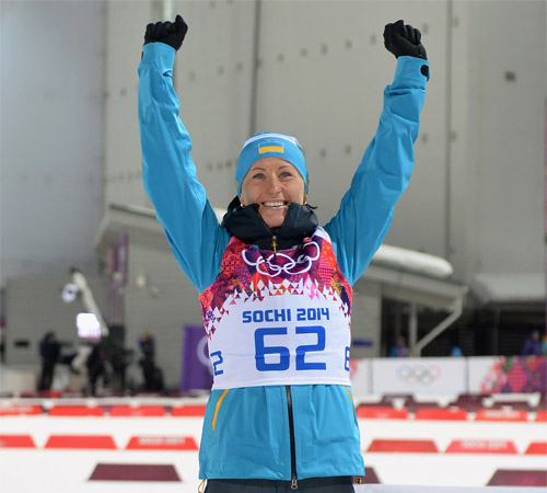 SOCHI, RUSSIA - FEBRUARY 09:  Bronze medalist Vita Semerenko of Ukraine celebrates during the flower ceremony following the Women's 7.5 km Sprint during day two of the Sochi 2014 Winter Olympics at Laura Cross-country Ski & Biathlon Center on February 9, 2014 in Sochi, Russia.  (Photo by Harry How/Getty Images)